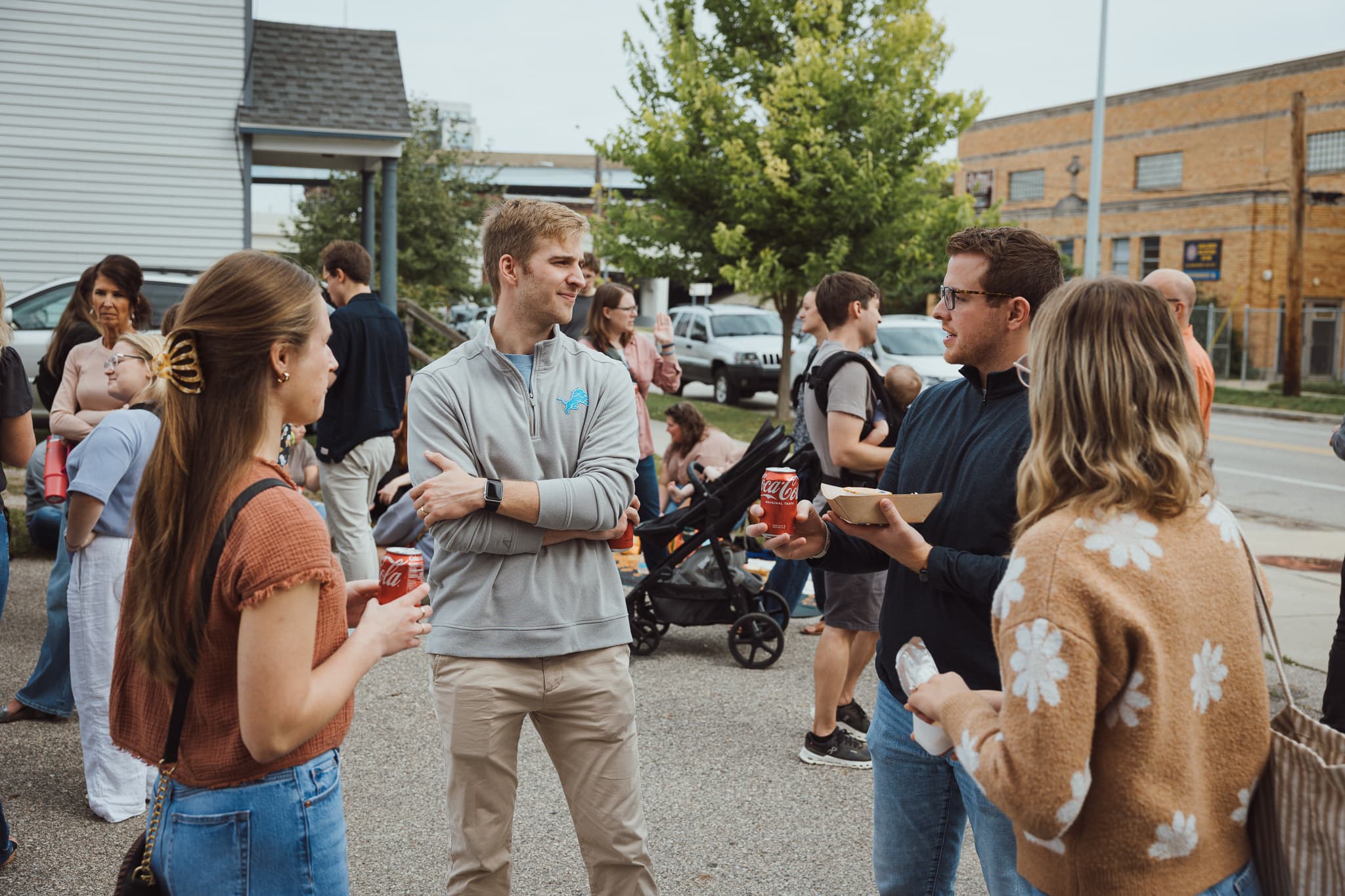 A larger group of people talking together outside after church