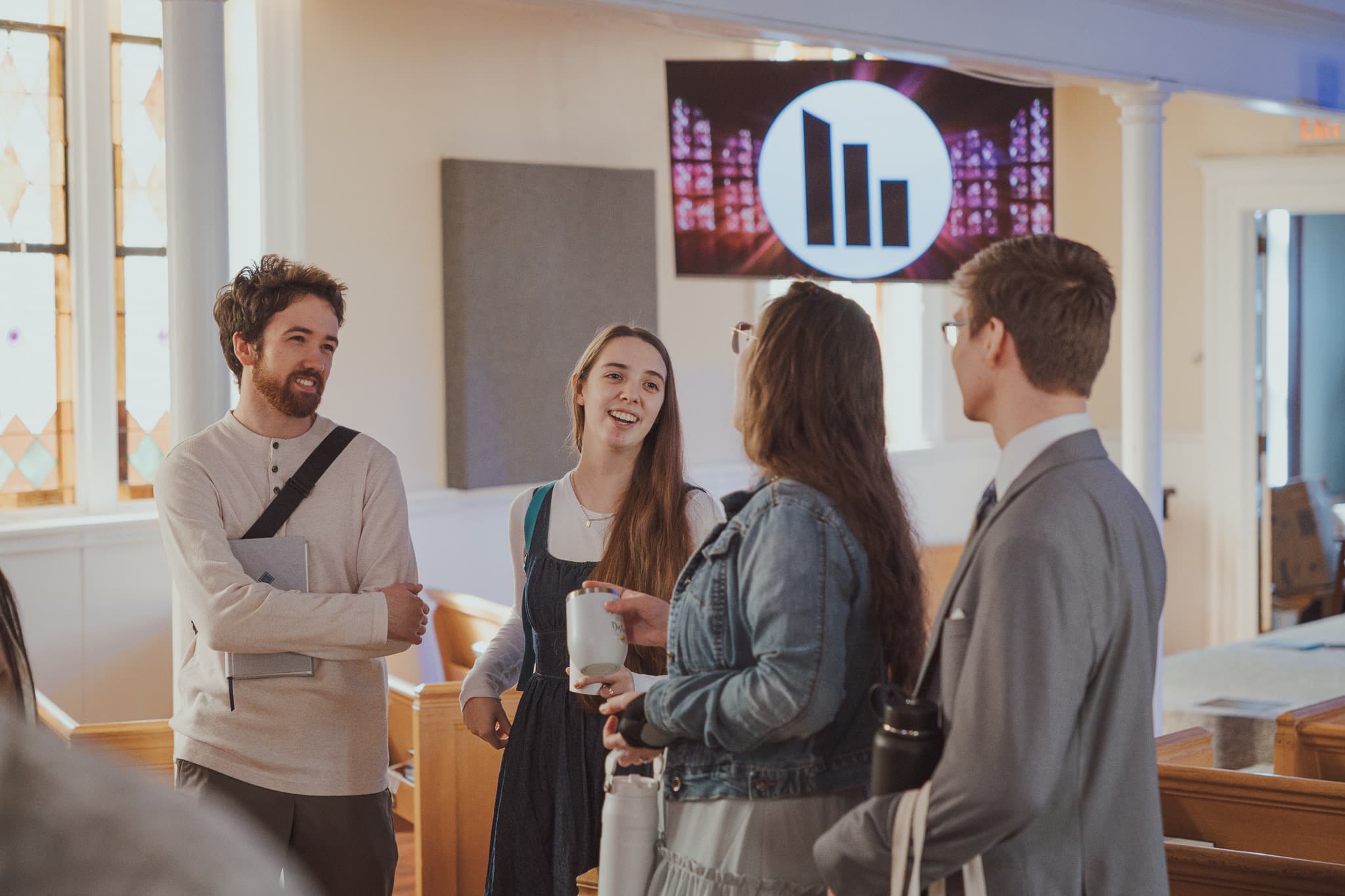 People talking over coffee at River City Church