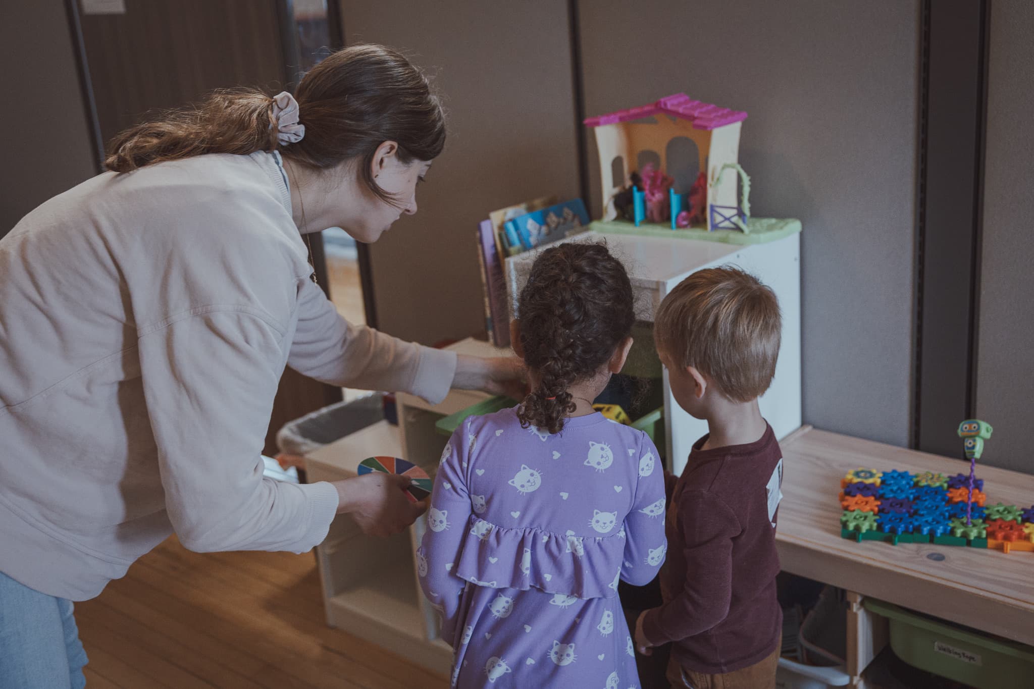 A River City Kids volunteer helping children play and settle in